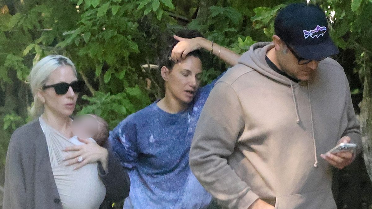 Gaga cradles her newborn, hinting at a secret family moment